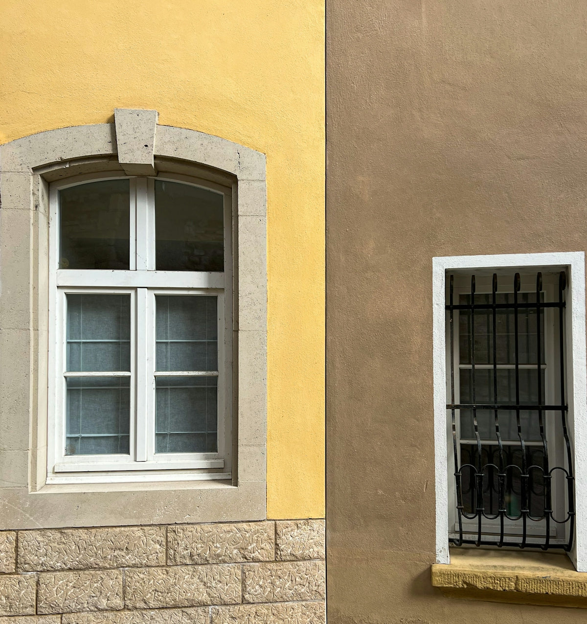 two windows with bars on the sides of them